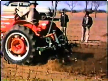 Farmers watching farm equipment demonstration