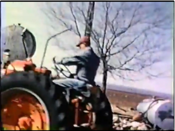 Grandpa on his tractor at the old home place