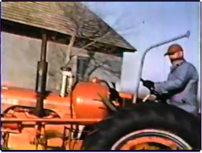 Grandpa on his tractor at the old home place